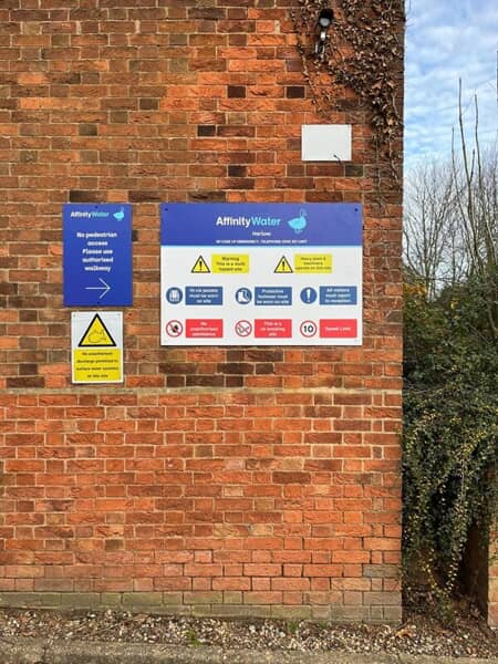 An image of brick mounted safety signage on a building.
